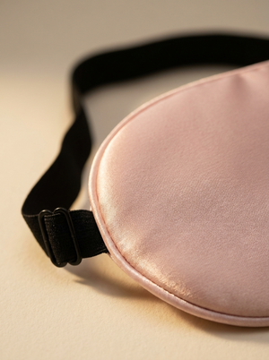 Close-up of the satin weave and adjustable strap buckle on the Blush Pink sleep mask