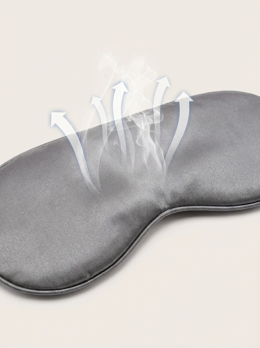 Silensea cooling sleep mask in Cloud Grey with arrows illustrating airflow across the satin surface