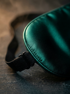 Close-up of the stitched edge and adjustable strap buckle on the Forest Green sleep mask